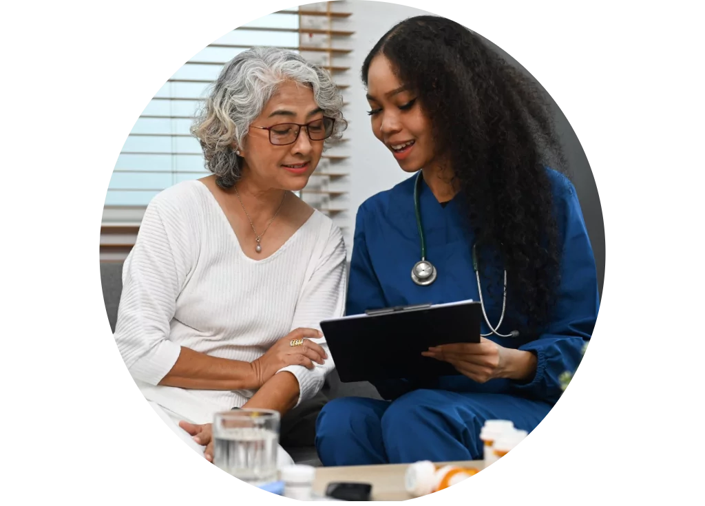 Doctor and a female patient looking at a tablet and discussing blood pressure