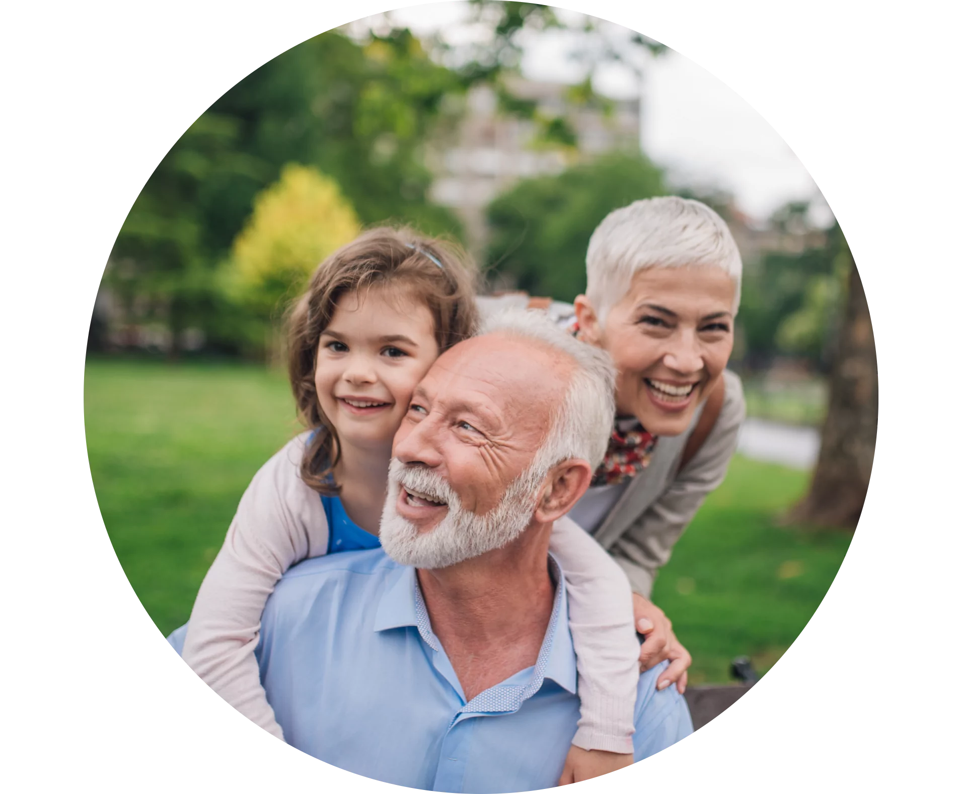 A man smiling with his daughter and granddaughter